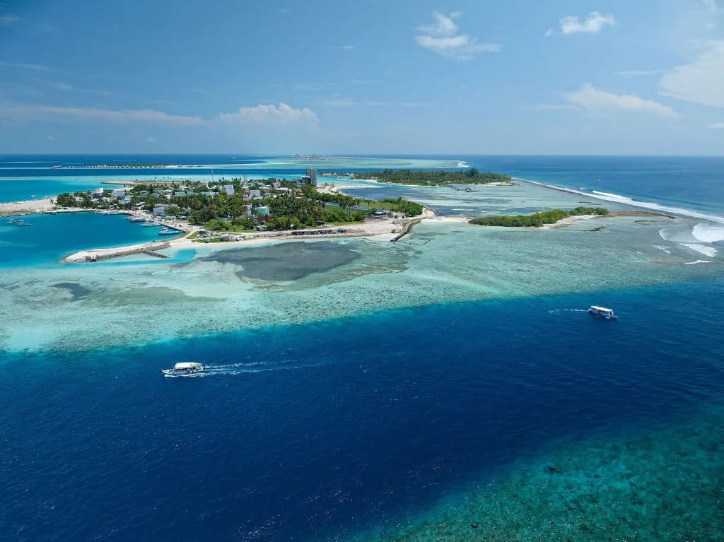 Guraidhoo from above, with its harbour, reef, boats and surrounding blue sea