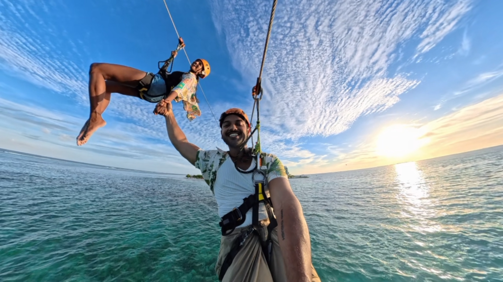 Two riders above the Maldivian sea at sunset
